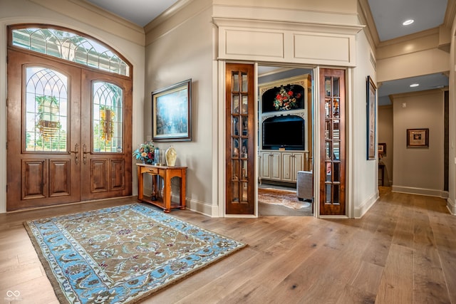 3075 Hurricane Rd, Franklin, IN 46131 - entryway featuring crown molding, light wood finished floors, and french doors