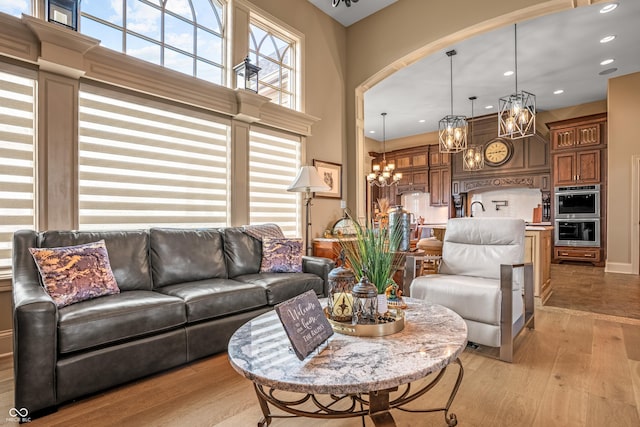 3075 Hurricane Rd, Franklin, IN 46131 - living area with light wood-style flooring, a chandelier, recessed lighting, and arched walkways