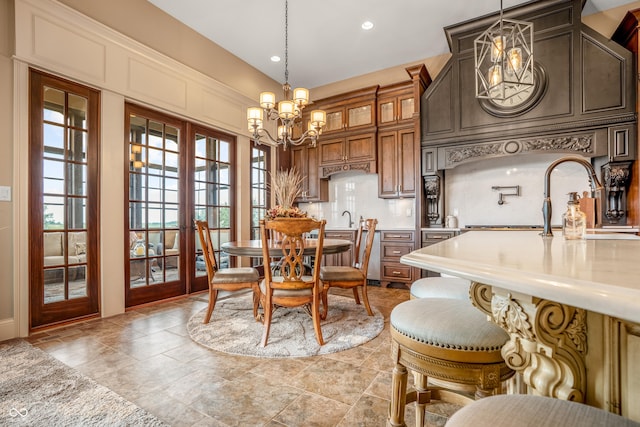 3075 Hurricane Rd, Franklin, IN 46131 - dining room featuring a chandelier, recessed lighting, and light stone finish flooring
