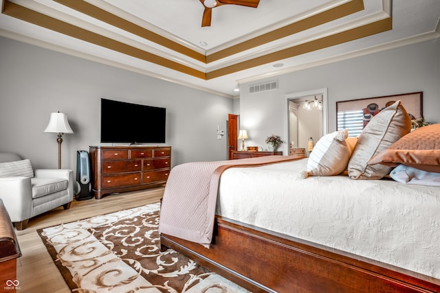3075 Hurricane Rd, Franklin, IN 46131 - bedroom with a tray ceiling, crown molding, wood finished floors, a chandelier, and a ceiling fan