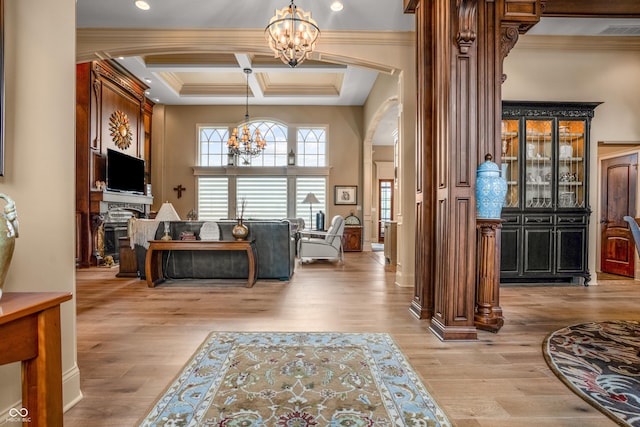 3075 Hurricane Rd, Franklin, IN 46131 - living area with a chandelier, arched walkways, ornamental molding, coffered ceiling, and wood finished floors