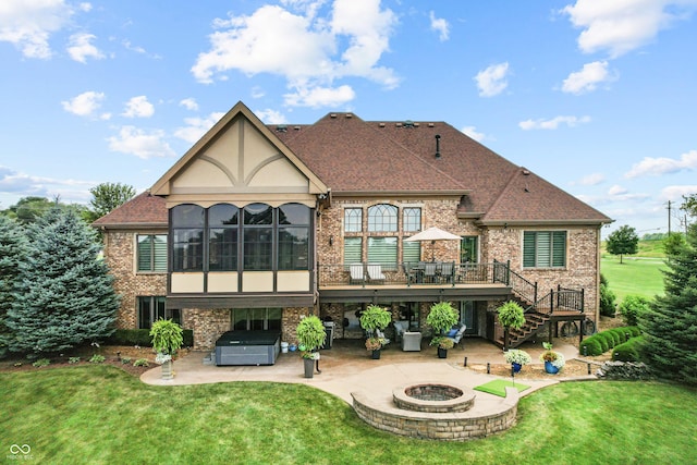 3075 Hurricane Rd, Franklin, IN 46131 - back of house with a hot tub, a patio area, brick siding, an outdoor fire pit, and a deck