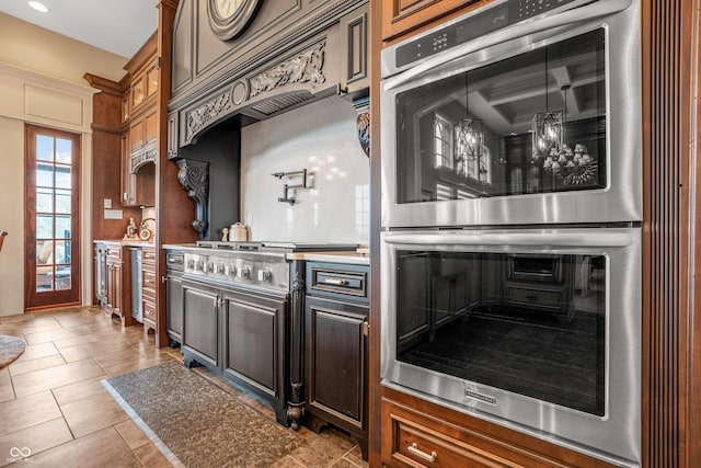 3075 Hurricane Rd, Franklin, IN 46131 - kitchen with stainless steel appliances, light countertops, tile patterned floors, and brown cabinets