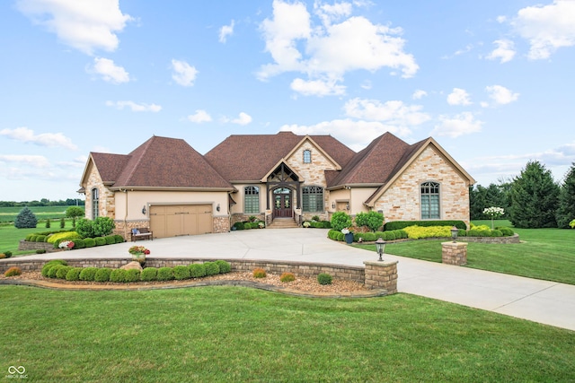 3075 Hurricane Rd, Franklin, IN 46131 - french country home with concrete driveway, stone siding, a front lawn, a garage, and stucco siding