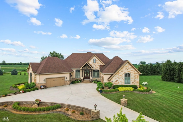 3075 Hurricane Rd, Franklin, IN 46131 - french country home featuring a garage, driveway, a front lawn, and stone siding
