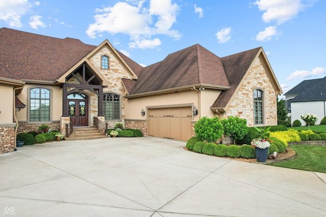 3075 Hurricane Rd, Franklin, IN 46131 - french provincial home featuring stone siding, french doors, concrete driveway, and a garage