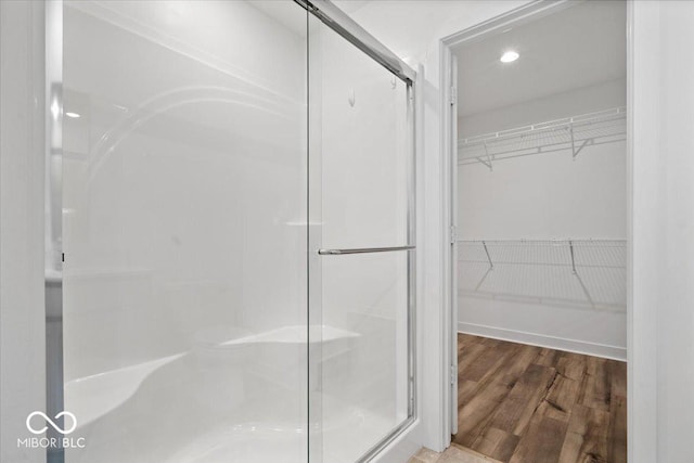 11431 Hartwell St, Indianapolis, IN 46235 - bathroom with a shower stall, a spacious closet, and wood finished floors