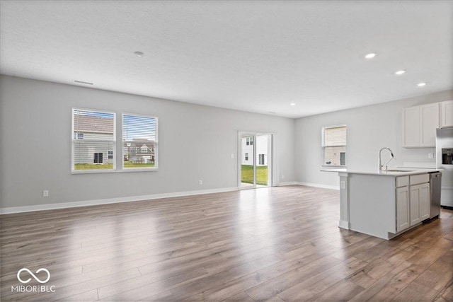 11431 Hartwell St, Indianapolis, IN 46235 - kitchen with open floor plan, appliances with stainless steel finishes, healthy amount of natural light, wood finished floors, and recessed lighting