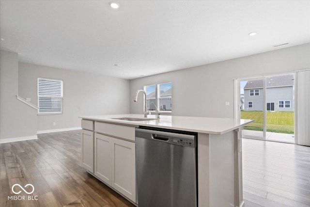 11431 Hartwell St, Indianapolis, IN 46235 - kitchen with dishwasher, wood finished floors, light countertops, a center island with sink, and recessed lighting