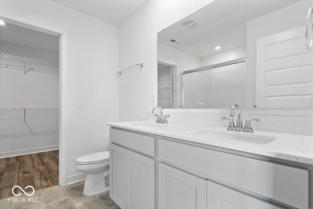 11431 Hartwell St, Indianapolis, IN 46235 - full bathroom with a walk in closet, a stall shower, double vanity, and recessed lighting