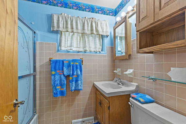 2752 Vinewood Dr, Speedway, IN 46224 - full bathroom with vanity, tile walls, enclosed tub / shower combo, and backsplash