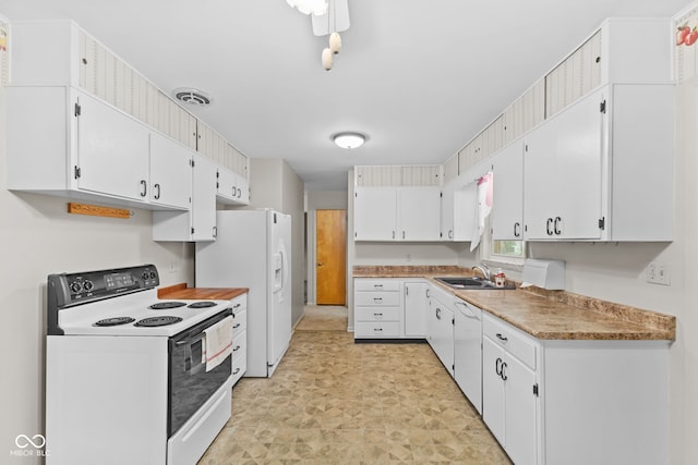 2752 Vinewood Dr, Speedway, IN 46224 - kitchen with white appliances, white cabinets, light countertops, and light floors
