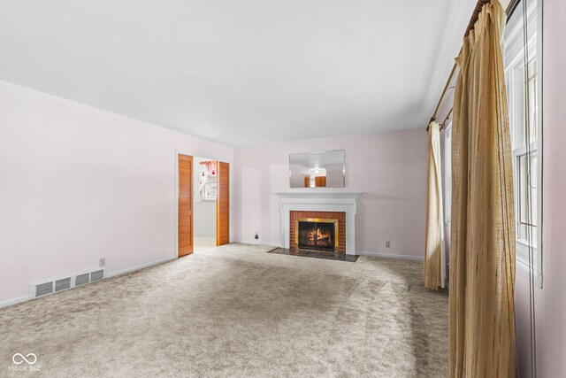 2752 Vinewood Dr, Speedway, IN 46224 - unfurnished living room with carpet and a fireplace