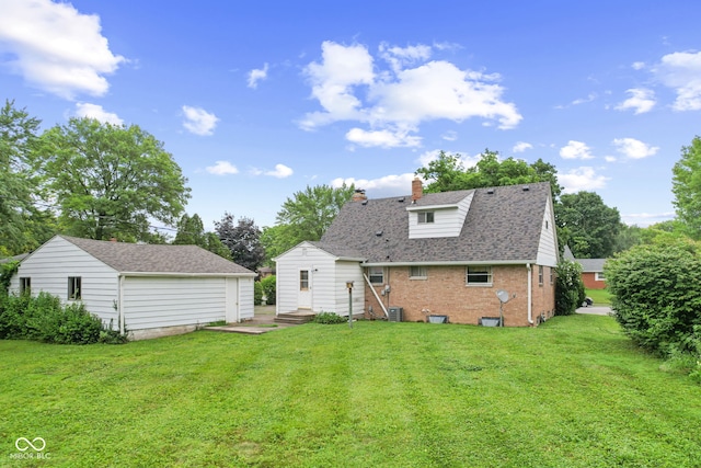 2752 Vinewood Dr, Speedway, IN 46224 - back of property featuring a chimney, a yard, brick siding, an outdoor structure, and roof with shingles