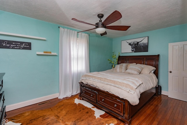 4729 W 100 N, Wolcott, IN 47995 - bedroom featuring hardwood / wood-style flooring, a textured ceiling, and ceiling fan