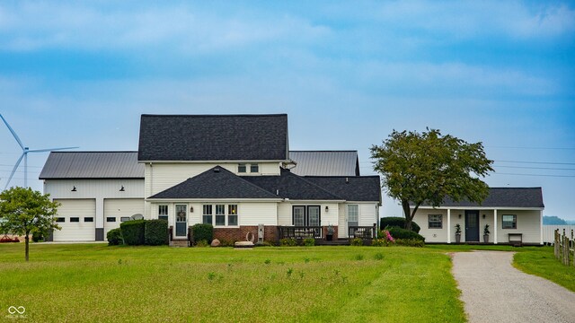 4729 W 100 N, Wolcott, IN 47995 - view of front of house featuring an attached garage, a front lawn, driveway, and a shingled roof