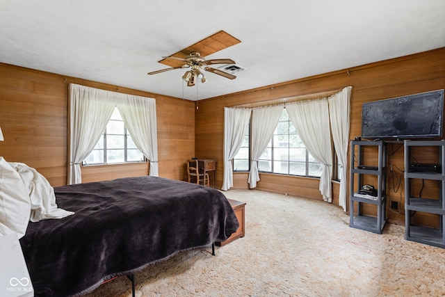 5519 N County Rd 550 E, Pittsboro, IN 46167 - carpeted bedroom featuring multiple windows, wooden walls, and ceiling fan