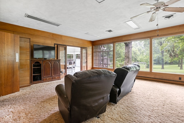 5519 N County Rd 550 E, Pittsboro, IN 46167 - carpeted home theater room featuring plenty of natural light, wood walls, and a ceiling fan