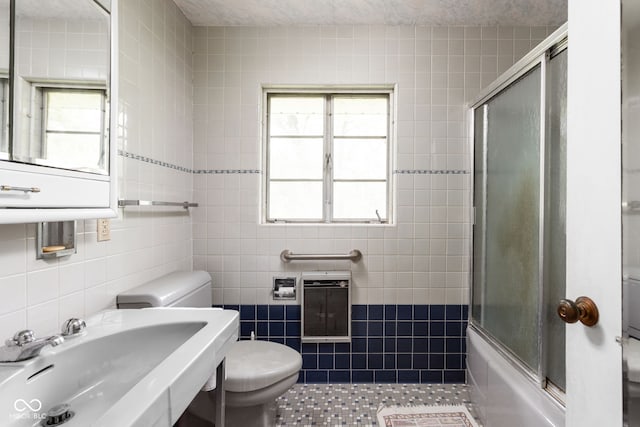 5519 N County Rd 550 E, Pittsboro, IN 46167 - bathroom featuring tile walls, heating unit, tile patterned flooring, and combined bath / shower with glass door