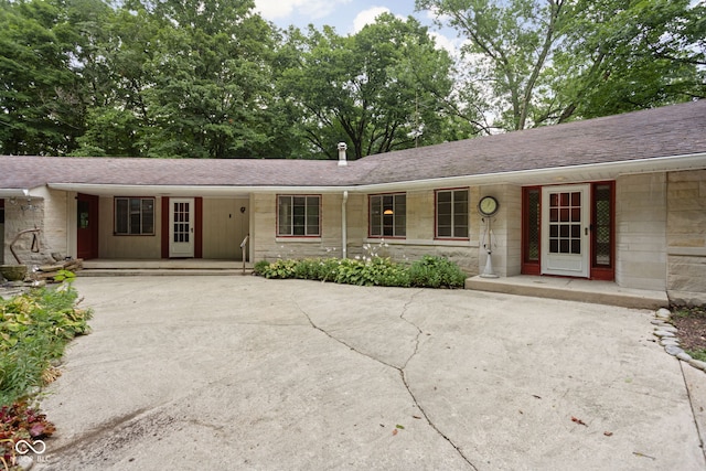 5519 N County Rd 550 E, Pittsboro, IN 46167 - single story home featuring driveway, stone siding, covered porch, and a shingled roof
