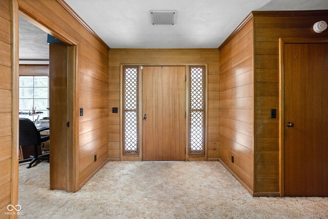 5519 N County Rd 550 E, Pittsboro, IN 46167 - carpeted foyer entrance with wooden walls and crown molding