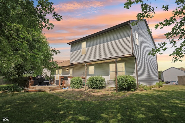 2426 Borgman Ct, Indianapolis, IN 46229 - back of house at dusk featuring a lawn and a wooden deck