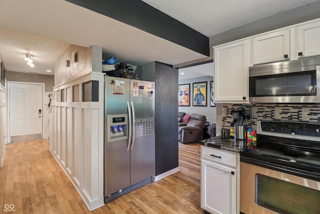 2426 Borgman Ct, Indianapolis, IN 46229 - kitchen featuring appliances with stainless steel finishes, white cabinets, decorative backsplash, and light wood-style flooring