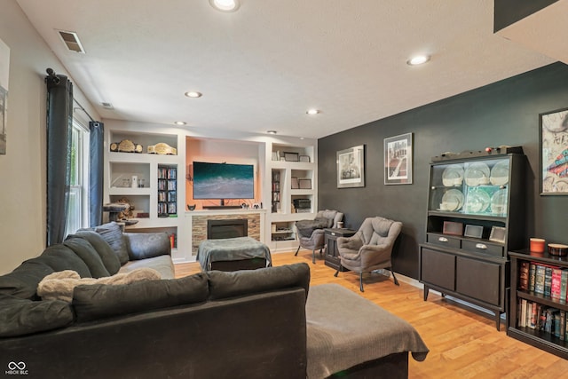 2426 Borgman Ct, Indianapolis, IN 46229 - living area with light wood finished floors, a fireplace, recessed lighting, and built in shelves