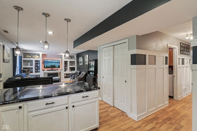 2426 Borgman Ct, Indianapolis, IN 46229 - kitchen featuring dark countertops, light wood-style flooring, and white cabinetry