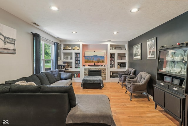 2426 Borgman Ct, Indianapolis, IN 46229 - living area with light wood finished floors, recessed lighting, a textured ceiling, a fireplace, and built in features