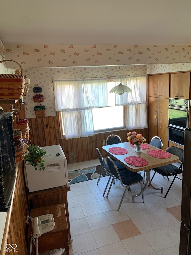 2010 N Winton Ave, Speedway, IN 46224 - dining room with wallpapered walls, healthy amount of natural light, light floors, and wood walls