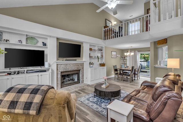 10832 Washington Bay Dr, Fishers, IN 46037 - living area featuring a chandelier, light wood-style flooring, built in shelves, high vaulted ceiling, and ceiling fan