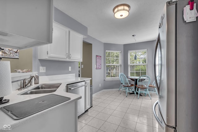 10832 Washington Bay Dr, Fishers, IN 46037 - kitchen featuring stainless steel appliances, white cabinetry, light countertops, light tile patterned flooring, and hanging light fixtures