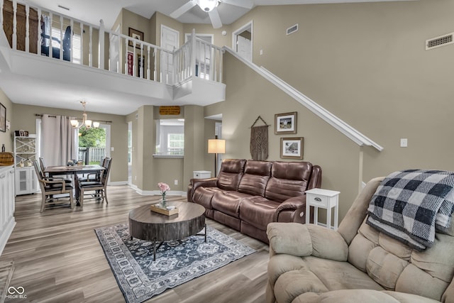 10832 Washington Bay Dr, Fishers, IN 46037 - living area with light wood-style flooring, a chandelier, a ceiling fan, and a high ceiling
