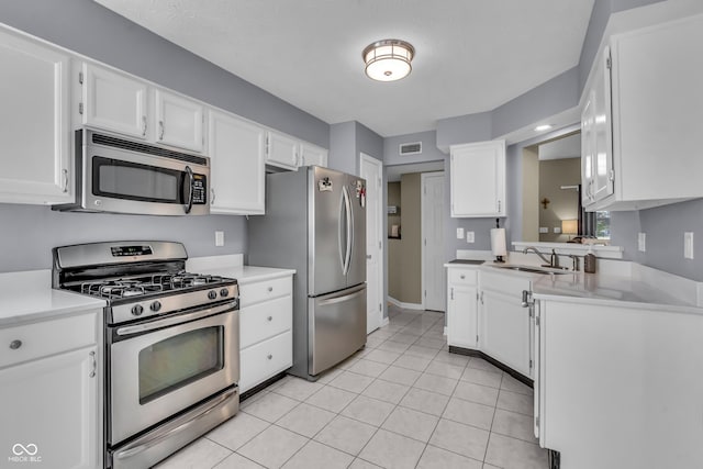 10832 Washington Bay Dr, Fishers, IN 46037 - kitchen featuring appliances with stainless steel finishes, white cabinets, light countertops, and light tile patterned floors