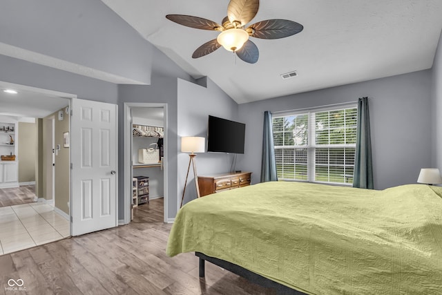 10832 Washington Bay Dr, Fishers, IN 46037 - bedroom with vaulted ceiling, light wood-type flooring, a walk in closet, and ceiling fan