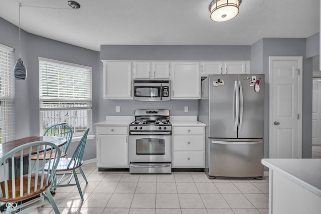 10832 Washington Bay Dr, Fishers, IN 46037 - kitchen with appliances with stainless steel finishes, light countertops, white cabinets, and light tile patterned floors