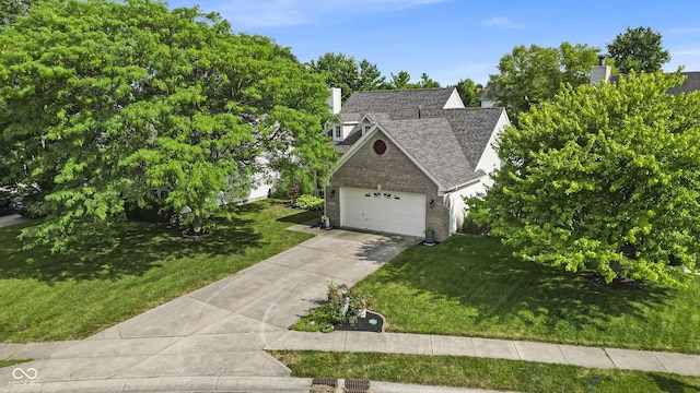 10832 Washington Bay Dr, Fishers, IN 46037 - view of front of home with a front lawn, concrete driveway, roof with shingles, and a chimney