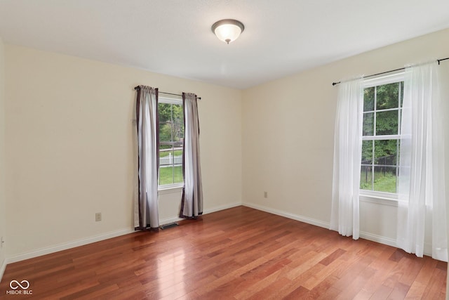 151 S St, Southport, IN 46227 - spare room with wood finished floors and plenty of natural light