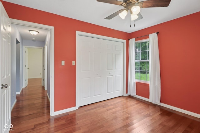 151 S St, Southport, IN 46227 - unfurnished bedroom with wood finished floors, a closet, and a ceiling fan