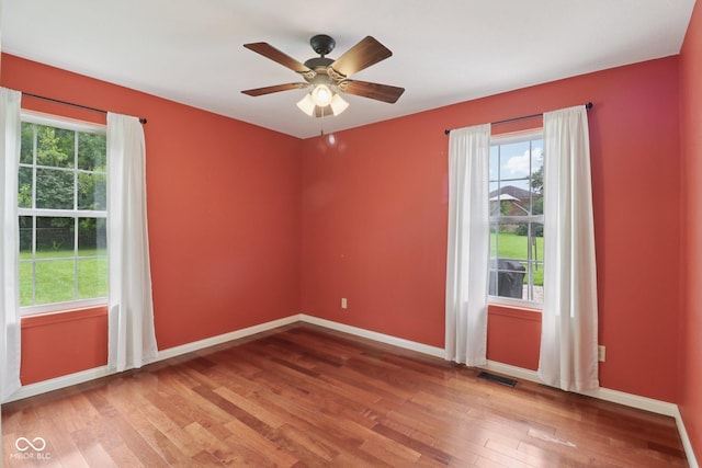 151 S St, Southport, IN 46227 - unfurnished room with plenty of natural light, wood finished floors, and a ceiling fan