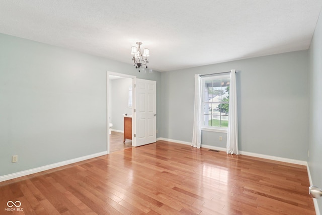 151 S St, Southport, IN 46227 - empty room featuring a chandelier and wood finished floors