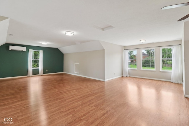 151 S St, Southport, IN 46227 - additional living space featuring an AC wall unit, light wood-type flooring, vaulted ceiling, and a ceiling fan