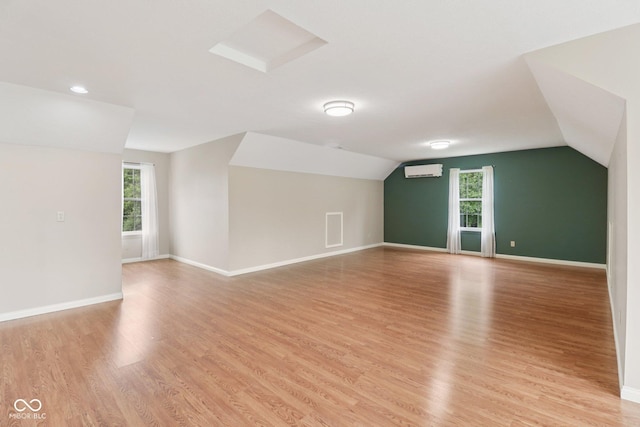 151 S St, Southport, IN 46227 - bonus room featuring a wall mounted AC, plenty of natural light, lofted ceiling, light wood-style floors, and recessed lighting