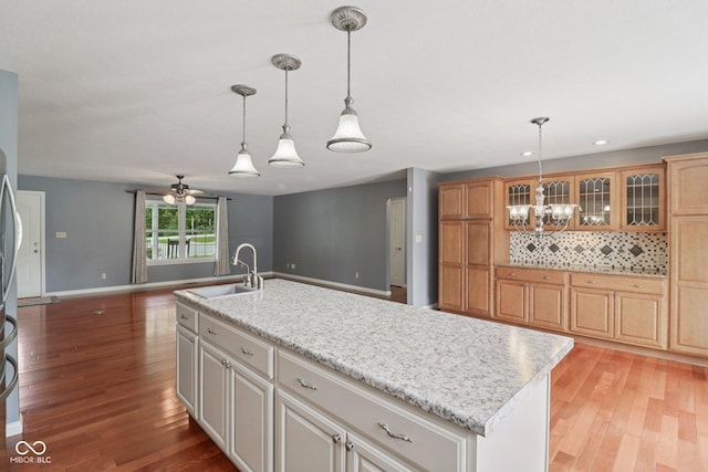 151 S St, Southport, IN 46227 - kitchen with a chandelier, light wood-style floors, a ceiling fan, glass insert cabinets, and recessed lighting