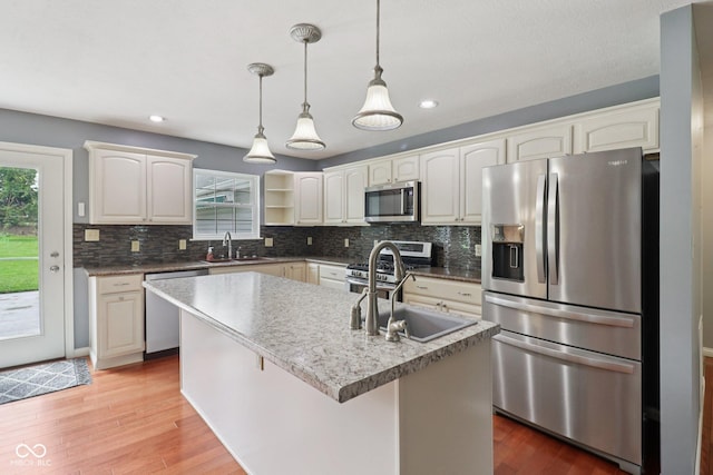 151 S St, Southport, IN 46227 - kitchen with stainless steel appliances, light wood-style floors, tasteful backsplash, decorative light fixtures, and open shelves