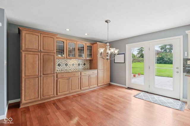 151 S St, Southport, IN 46227 - kitchen featuring backsplash, a chandelier, light wood-style flooring, pendant lighting, and recessed lighting