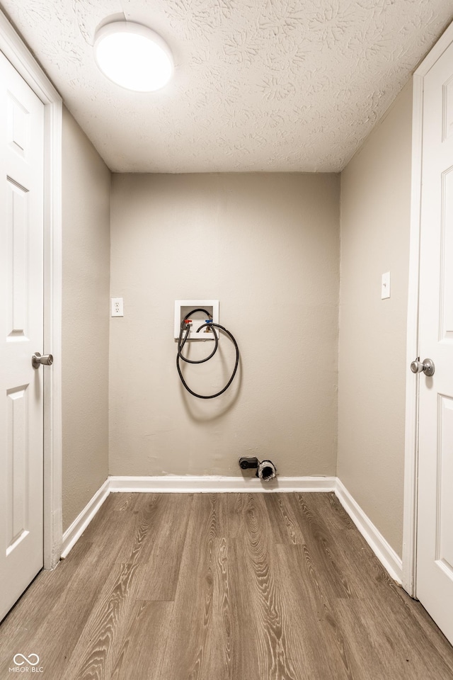 3613 Moller Rd, Indianapolis, IN 46224 - laundry area featuring hookup for a washing machine, wood finished floors, and a textured ceiling