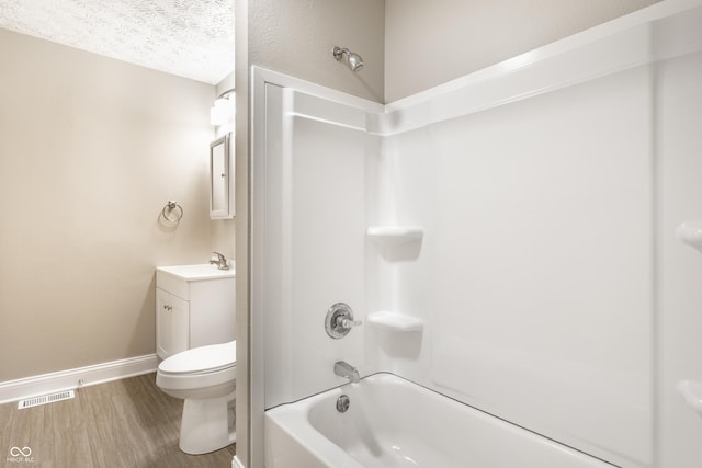 3613 Moller Rd, Indianapolis, IN 46224 - full bathroom featuring vanity, shower / tub combination, wood finished floors, and a textured ceiling