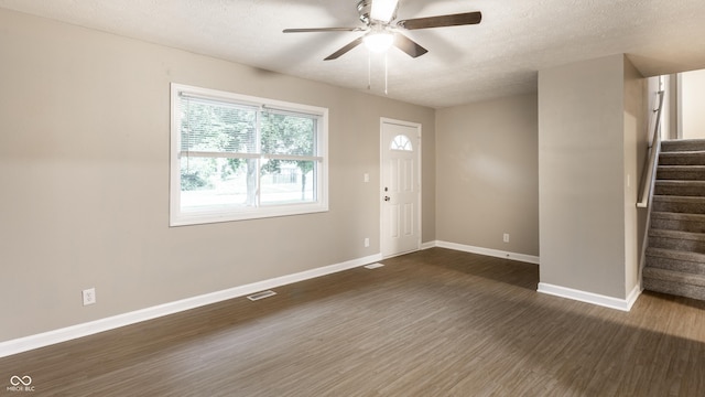 3613 Moller Rd, Indianapolis, IN 46224 - foyer entrance featuring dark wood-style floors, stairs, a ceiling fan, and a textured ceiling